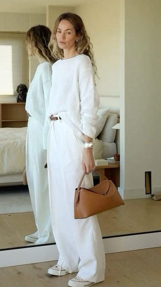 Clean Girl Aesthetic outfit featuring wide-leg white pants, a textured white sweater, and neutral accessories — minimalist capsule wardrobe inspiration 2025