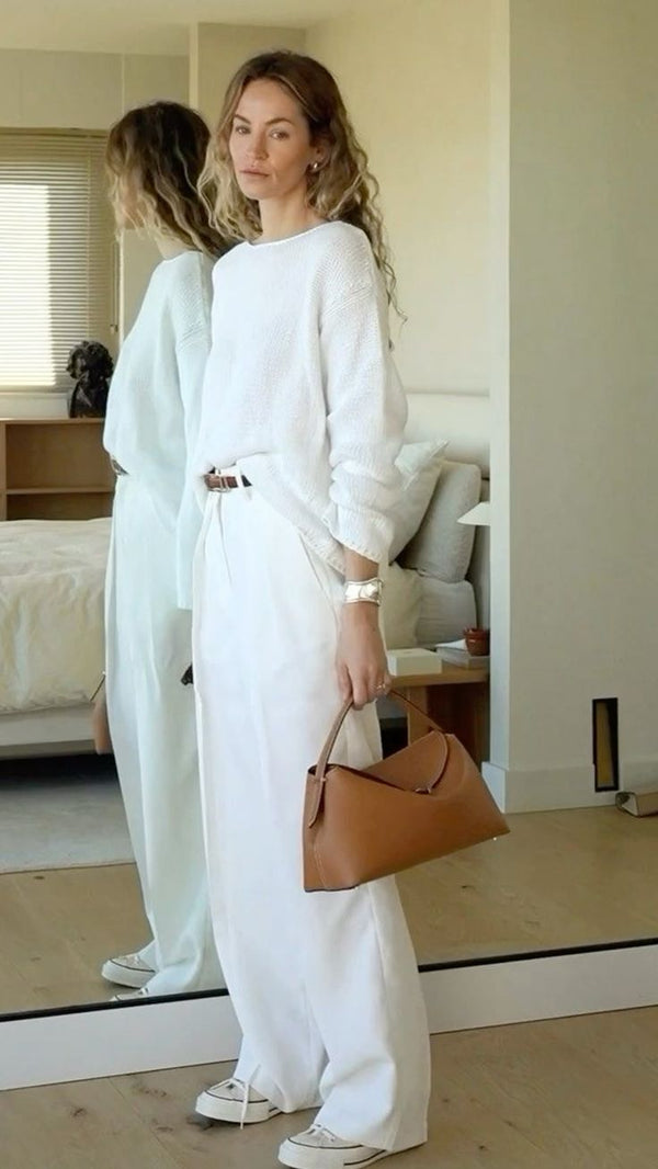Clean Girl Aesthetic outfit featuring wide-leg white pants, a textured white sweater, and neutral accessories — minimalist capsule wardrobe inspiration 2025
